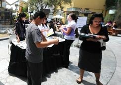 Job seekers wait in line to have their resumes reviewed at the Anaheim/Orange County Job Fair in Anaheim, Calif., on June 2. 