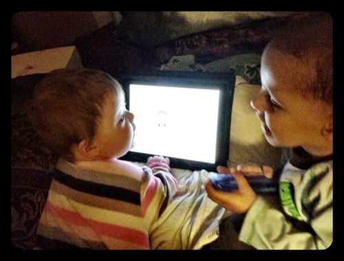 Daniel shows Lily how to use the iPad