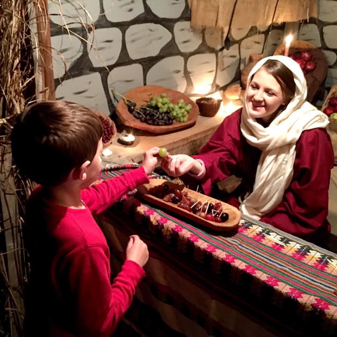Daniel getting a grape from a merchant in Bethlehem.