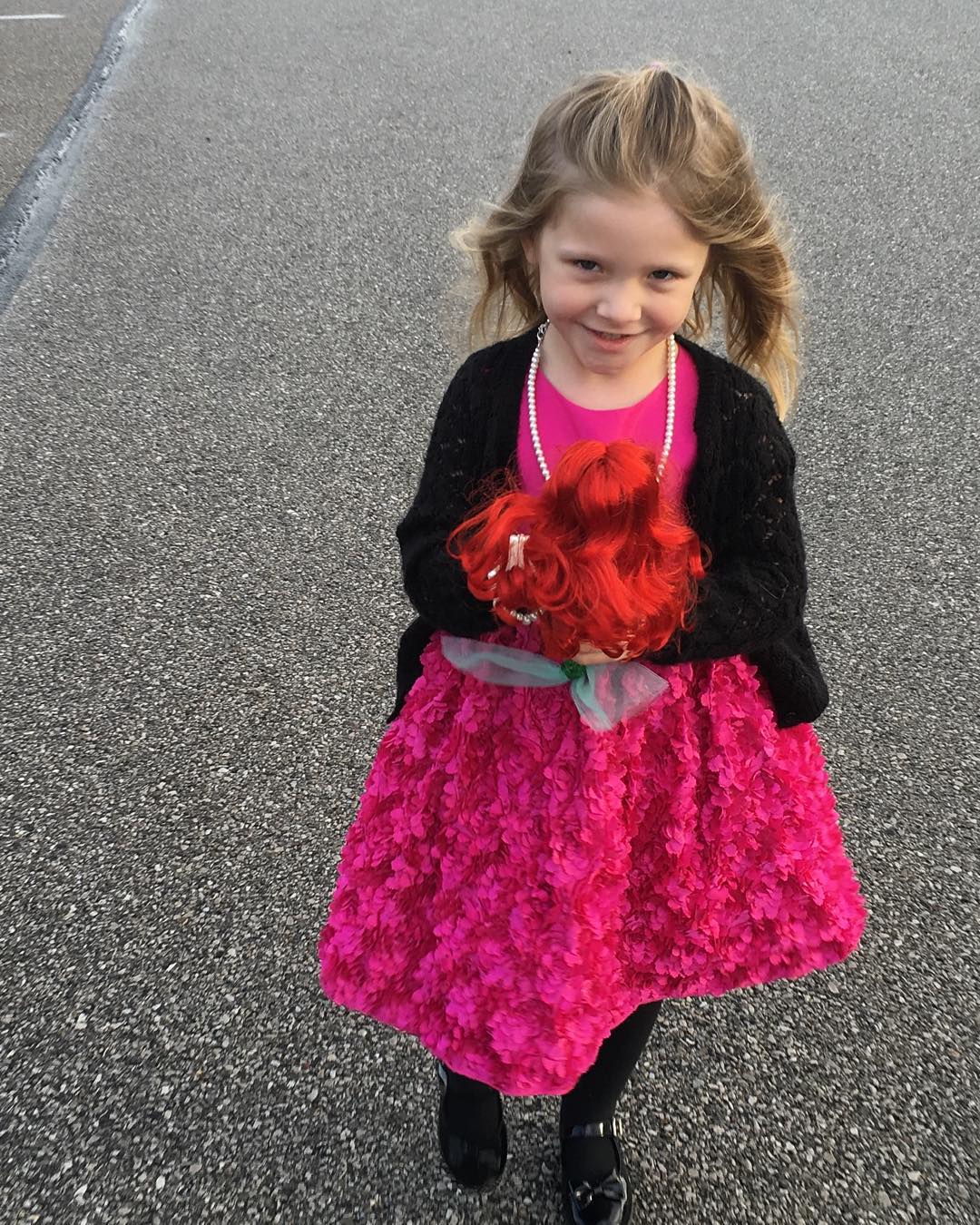 Lily taking her mermaid doll to church